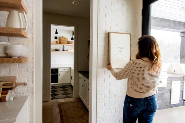 Wash the Plate | Wall Art: Soft White-Black Text / Light Brown Frame / 8 inches x 12 inches