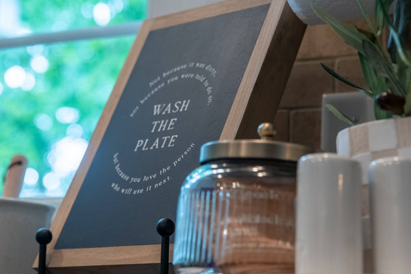 Wash the Plate | Wall Art: Soft White-Black Text / Light Brown Frame / 8 inches x 12 inches