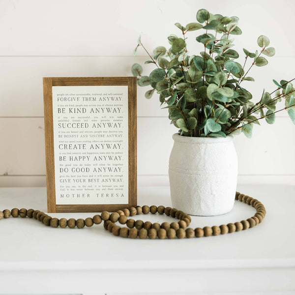 Love them Anyway | Mother Teresa | Wall Art: Black-White Text / Light Brown Frame / 8 inches x 12 inches