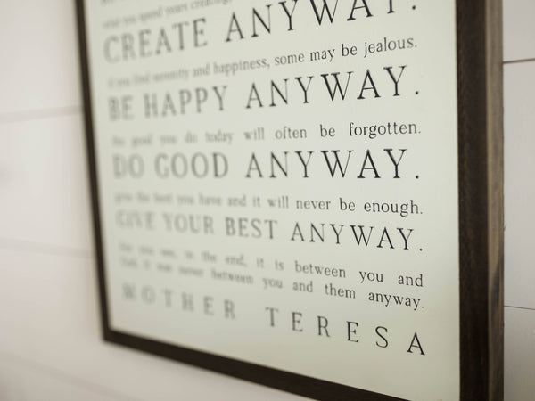 Love them Anyway | Mother Teresa | Wall Art: Black-White Text / Light Brown Frame / 8 inches x 12 inches