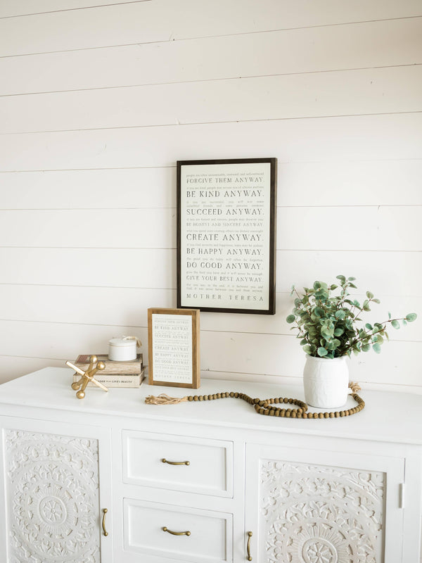 Love them Anyway | Mother Teresa | Wall Art: Soft White-Black Text / Light Brown Frame / 8 inches x 12 inches