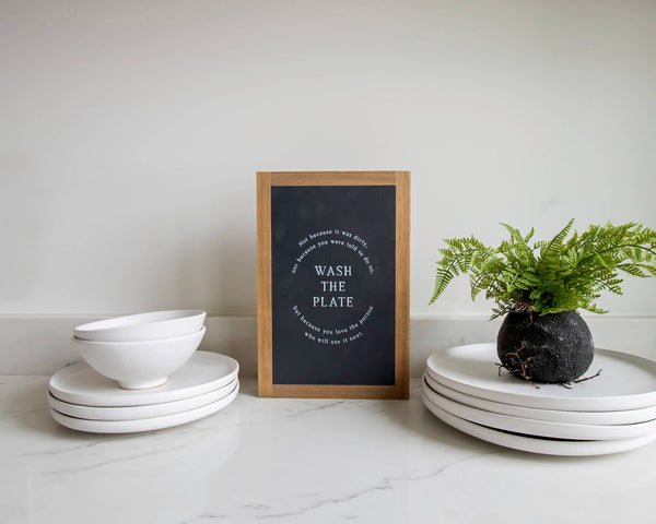 Wash the Plate | Wall Art: Soft White-Black Text / Light Brown Frame / 8 inches x 12 inches